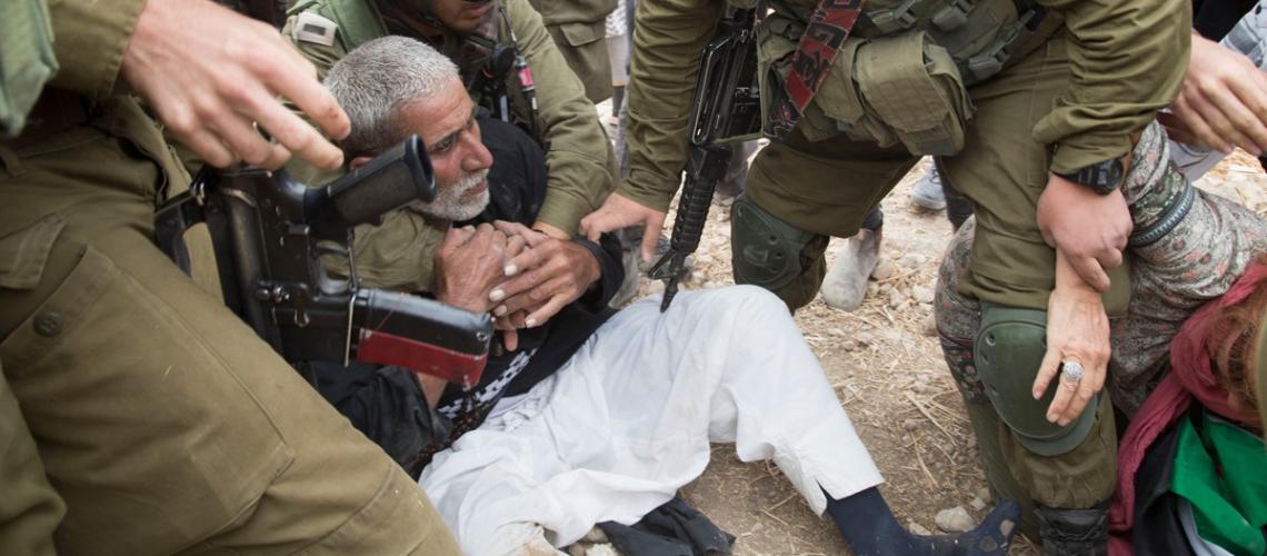 Israeli soldiers occupying Palestinian farmers' lands