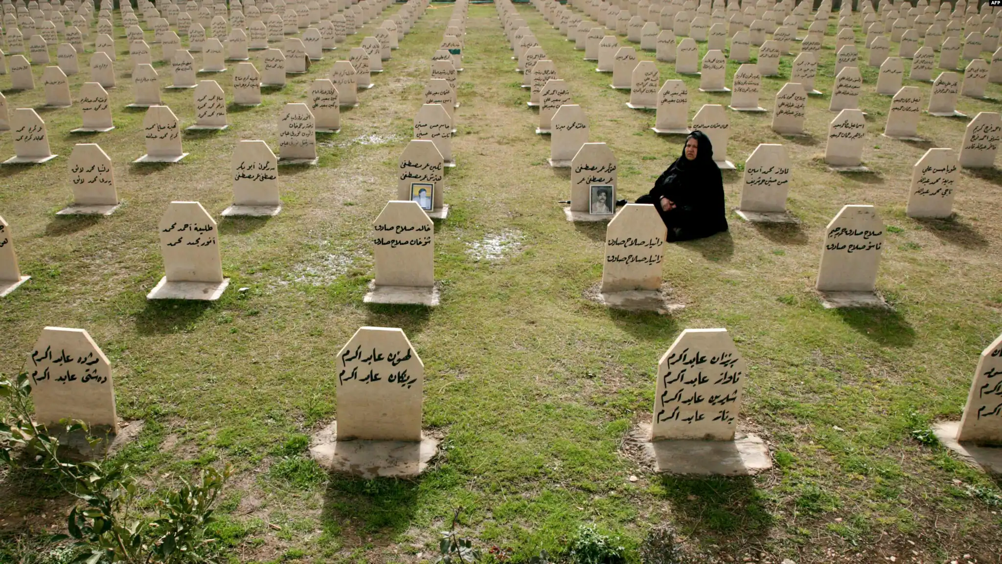 A Kurdish woman visits the graves of her relatives who were killed in the gas attack in 1988 on the 24th anniversary of the attack at the memorial site to the victims in the Iraqi town of Halabja.